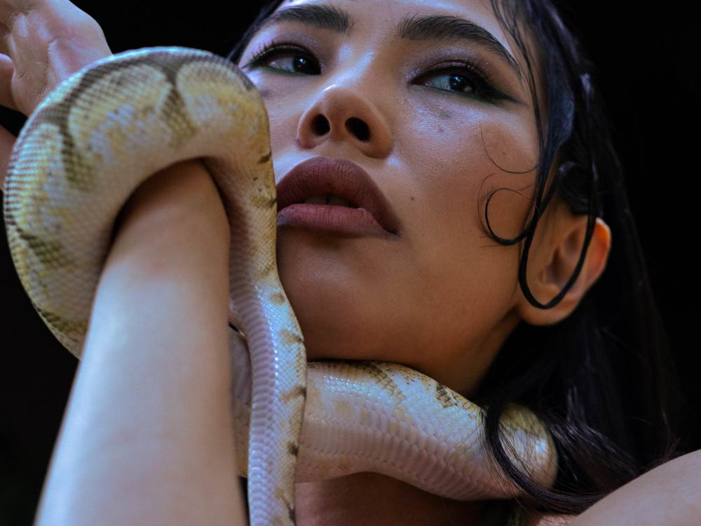 snake wrapped around womans neck